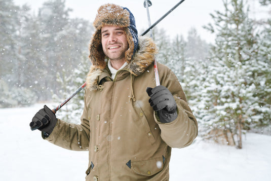 A man skiing outdoors in winter wearing MCTi Ski Gloves